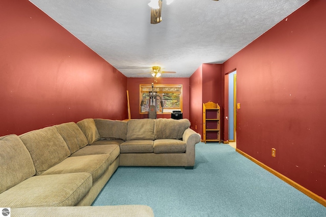 living room featuring ceiling fan, a textured ceiling, and carpet floors