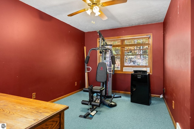 workout room with a textured ceiling, carpet floors, and ceiling fan