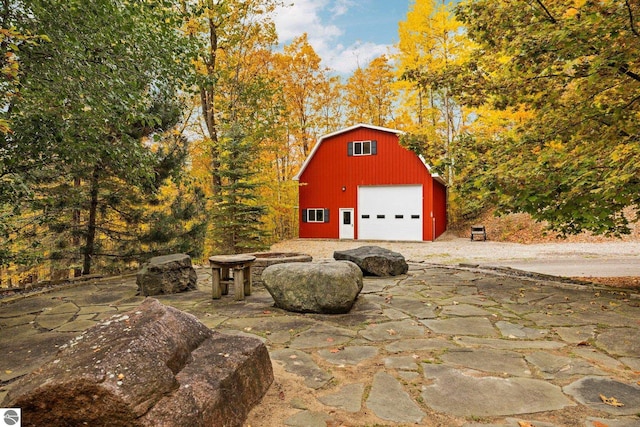 view of patio / terrace featuring an outbuilding and a garage