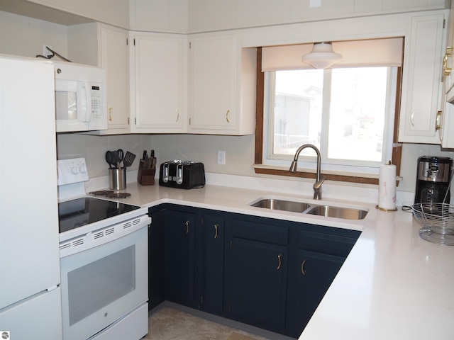 kitchen featuring decorative backsplash, sink, blue cabinetry, white cabinetry, and white appliances