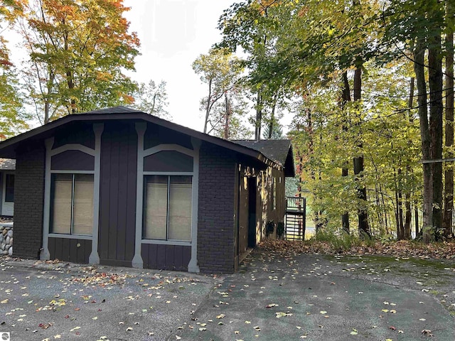 5417 Golfview Rd, Bellaire, MI 49615 - view of side of home with brick siding
