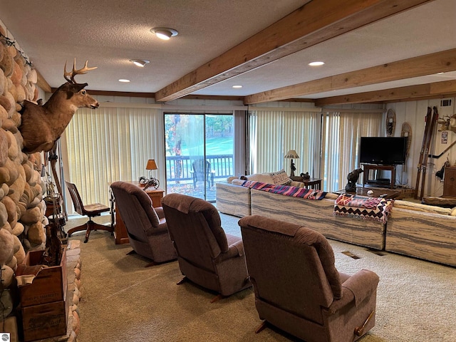 living room featuring beamed ceiling, carpet, and a textured ceiling