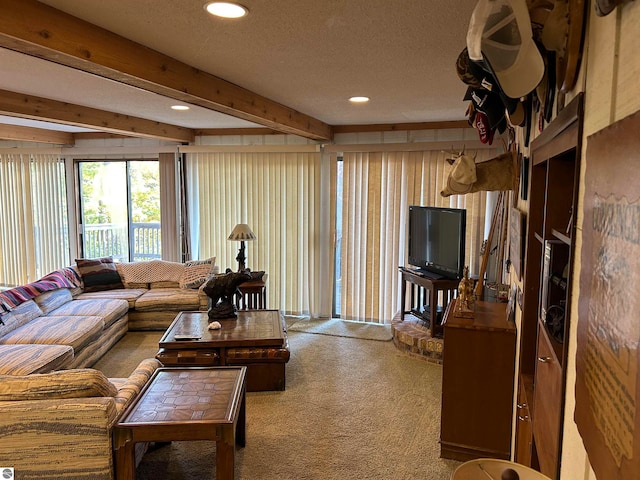 carpeted living room featuring beam ceiling and a textured ceiling