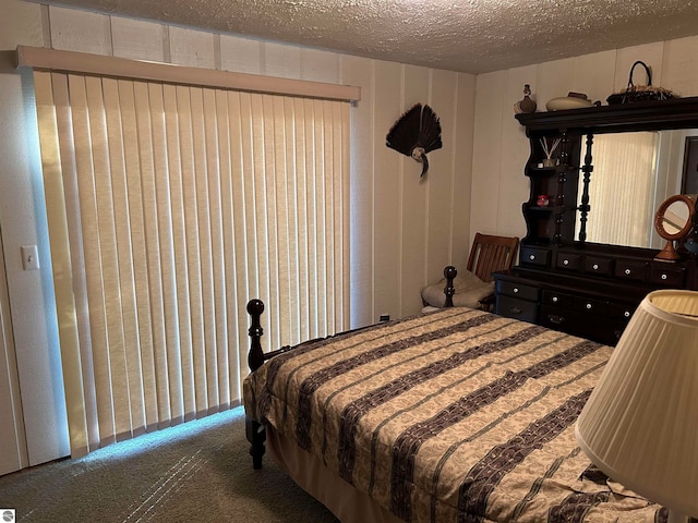 bedroom featuring carpet floors and a textured ceiling