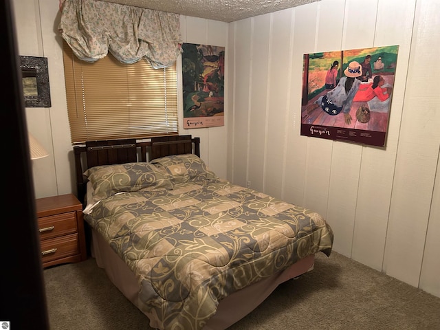 bedroom with carpet floors and a textured ceiling