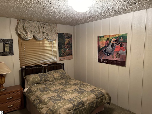 5417 Golfview Rd, Bellaire, MI 49615 - bedroom with a decorative wall, carpet, and a textured ceiling