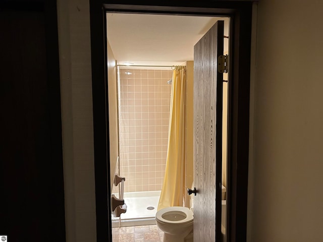 bathroom with toilet and walk in shower