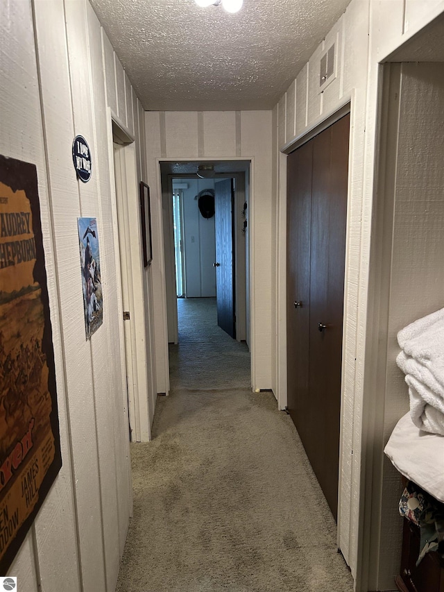 5417 Golfview Rd, Bellaire, MI 49615 - corridor with a textured ceiling and carpet floors