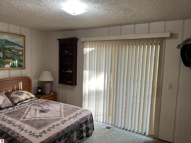 bedroom with carpet and a textured ceiling