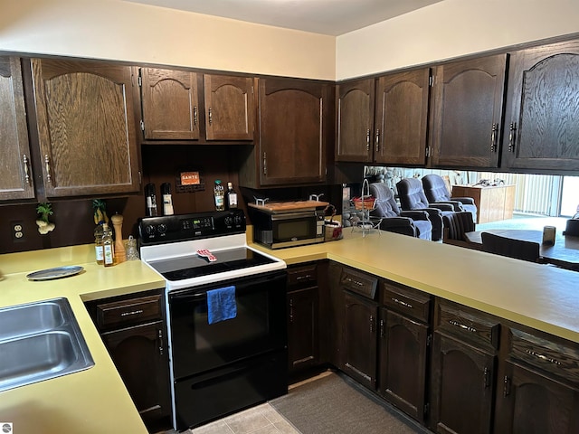 kitchen with sink, kitchen peninsula, light tile patterned floors, white electric range oven, and dark brown cabinets