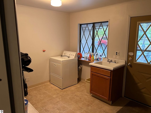 laundry room featuring a healthy amount of sunlight, cabinets, sink, and washer / clothes dryer