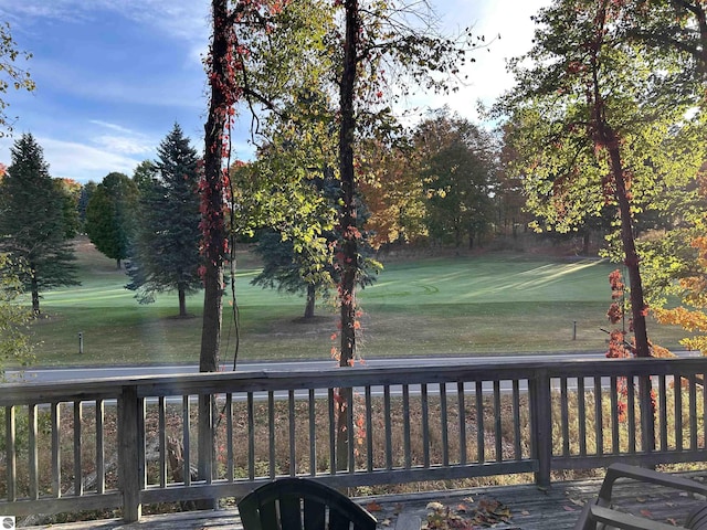 5417 Golfview Rd, Bellaire, MI 49615 - wooden deck with view of golf course and a lawn