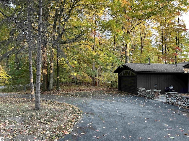 5417 Golfview Rd, Bellaire, MI 49615 - exterior space with a forest view and driveway