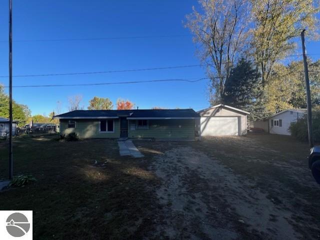 view of front facade featuring an outbuilding and a garage