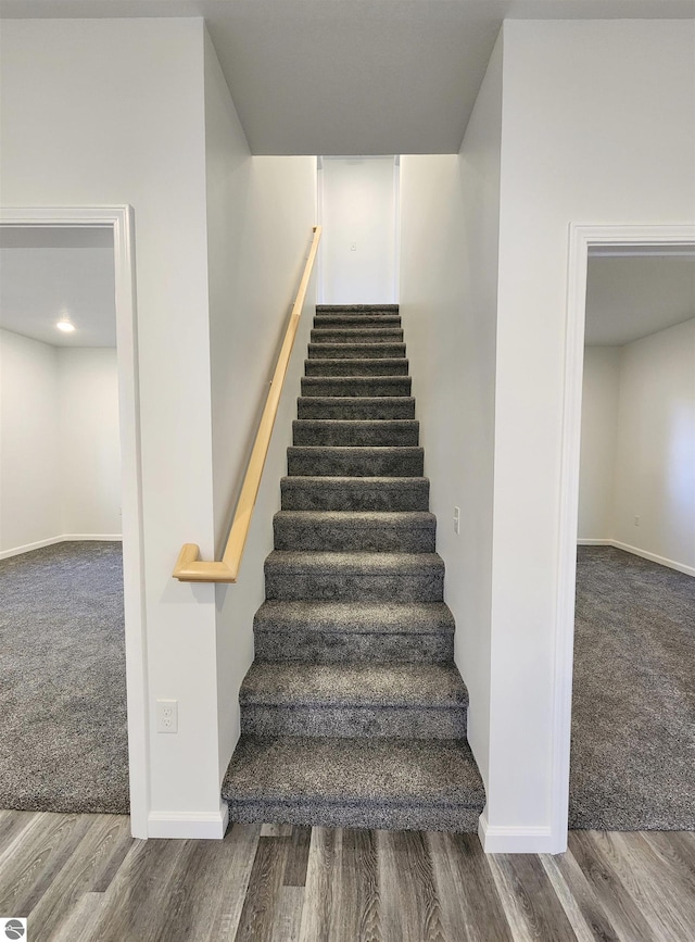 stairs featuring hardwood / wood-style flooring