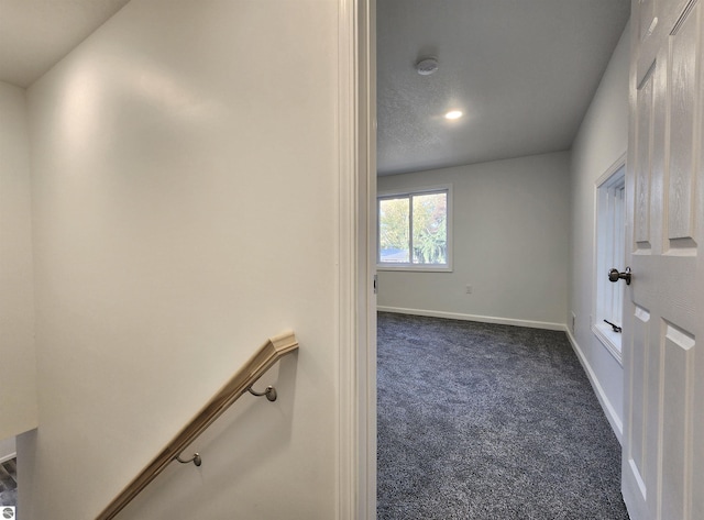 interior space featuring dark carpet