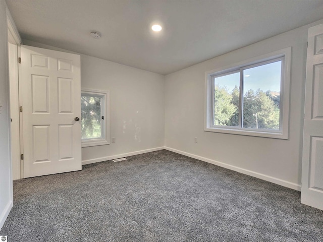 empty room featuring dark carpet