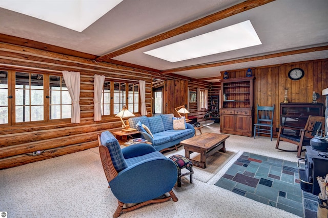 living room with beam ceiling, carpet, and rustic walls