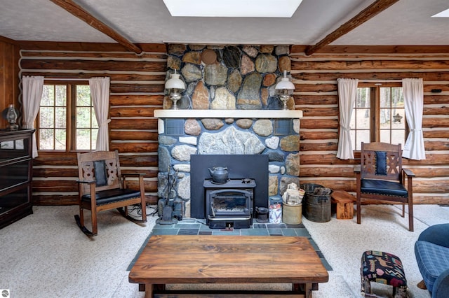 living room with beam ceiling, a healthy amount of sunlight, and a wood stove