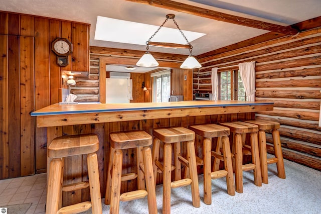 bar featuring a wall unit AC and white fridge