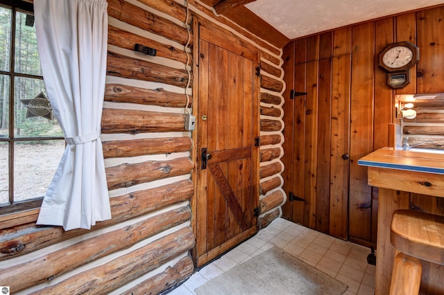 bathroom with wood walls and tile patterned flooring