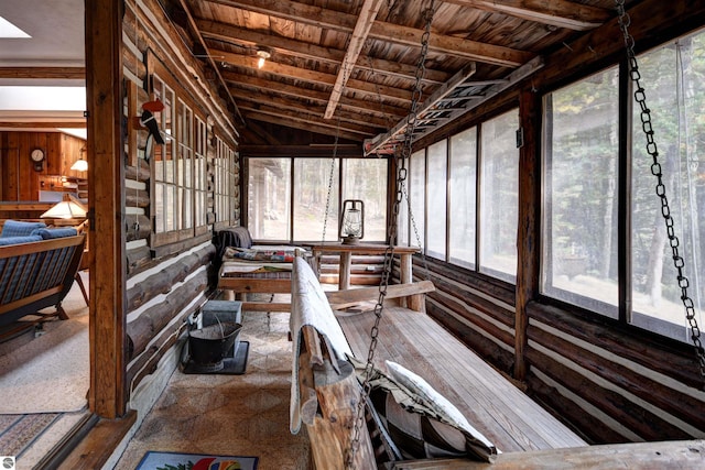 unfurnished sunroom with wooden ceiling and vaulted ceiling