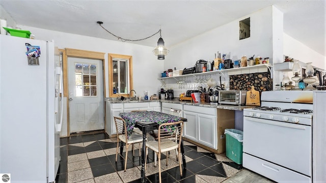 kitchen with white appliances, white cabinetry, decorative light fixtures, and sink