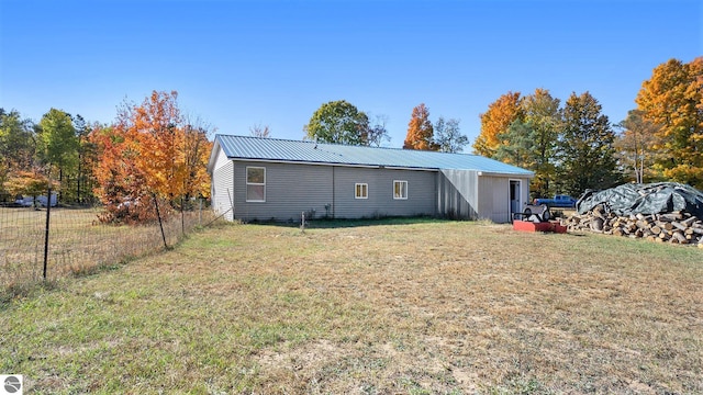 rear view of property with a lawn