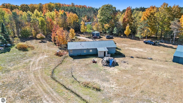 drone / aerial view featuring a wooded view