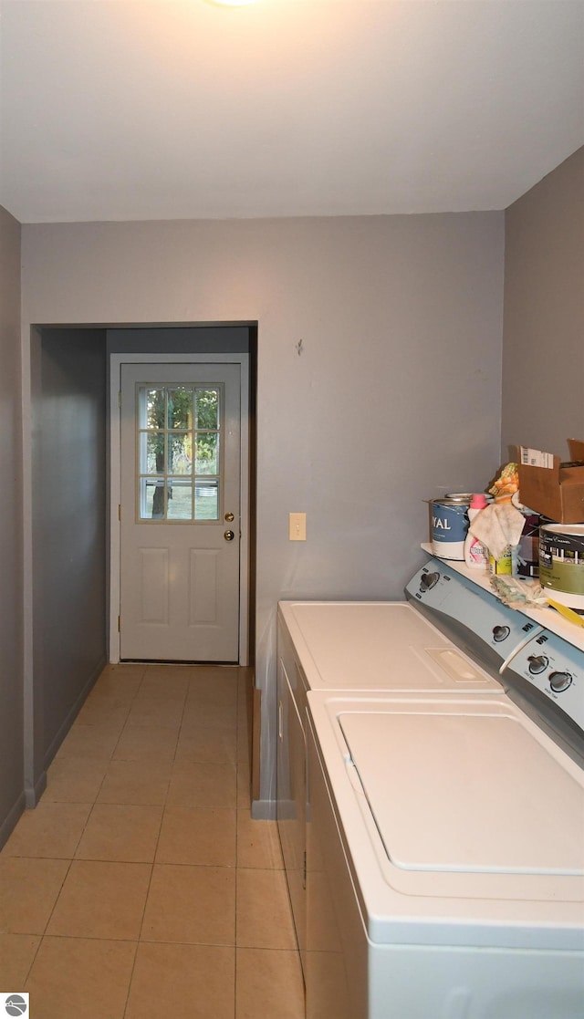 laundry room featuring light tile patterned flooring and separate washer and dryer