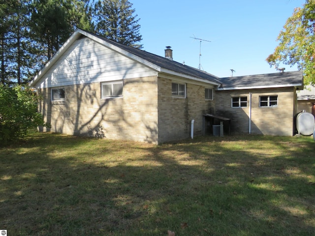 back of property with a lawn