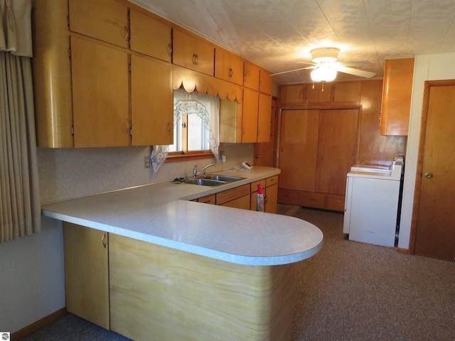 kitchen with sink, ceiling fan, kitchen peninsula, and washer / clothes dryer