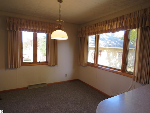 unfurnished dining area featuring a mountain view and carpet floors