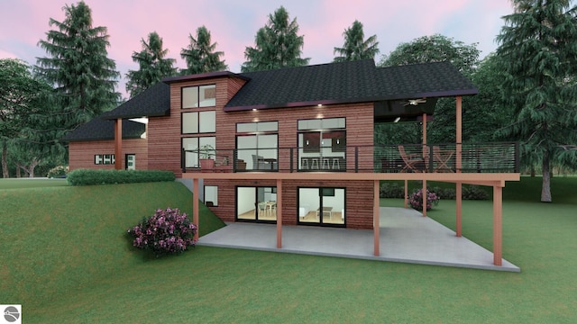 back house at dusk featuring a patio and a lawn