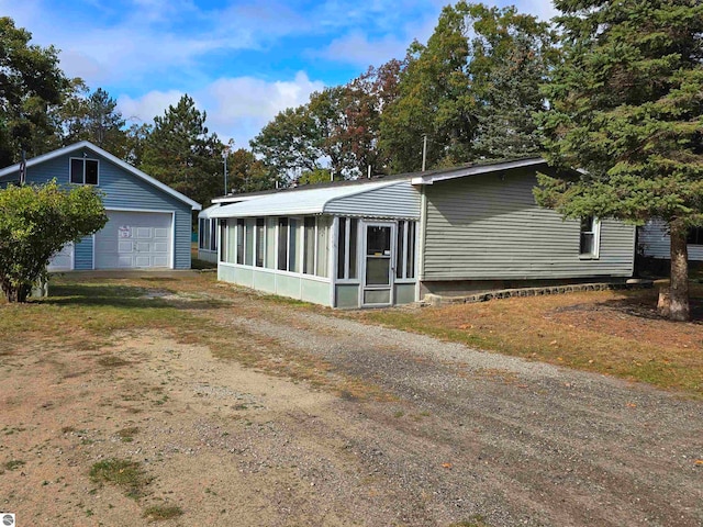 view of front of property with a garage and a sunroom