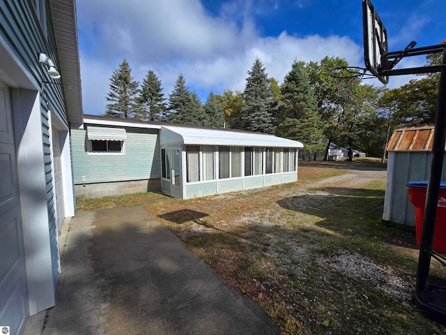 view of side of home with a sunroom