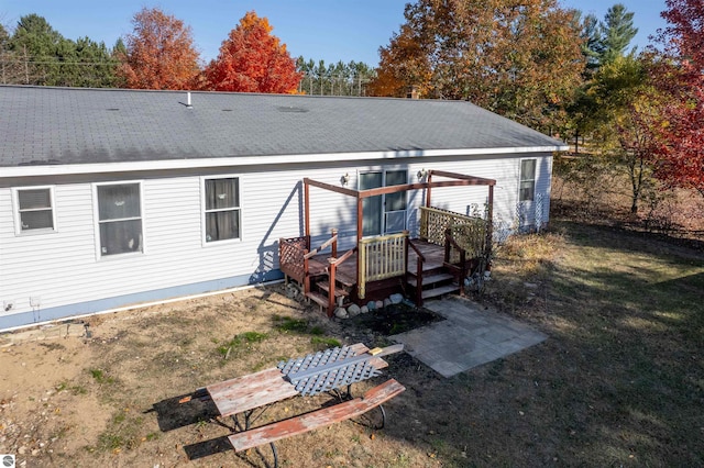 back of house with a lawn and a wooden deck