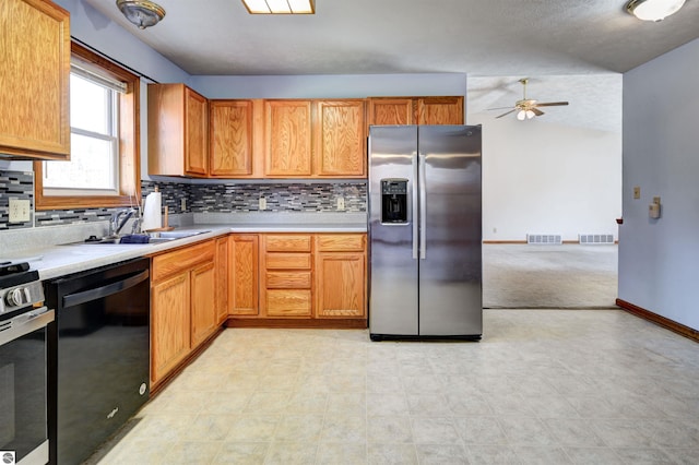 kitchen featuring ceiling fan, sink, stainless steel appliances, backsplash, and lofted ceiling