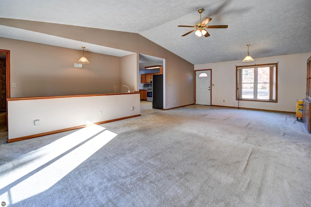 unfurnished living room with ceiling fan, sink, light carpet, and lofted ceiling