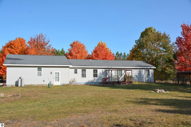 rear view of house with a lawn