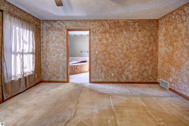 spare room featuring ceiling fan and a textured ceiling