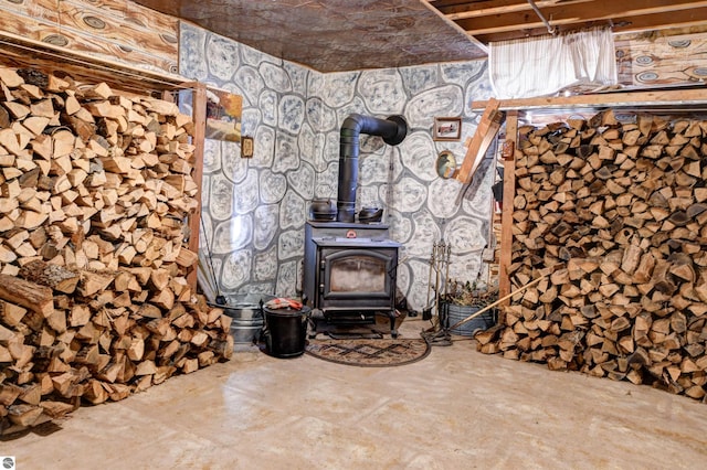 room details featuring a wood stove and concrete floors