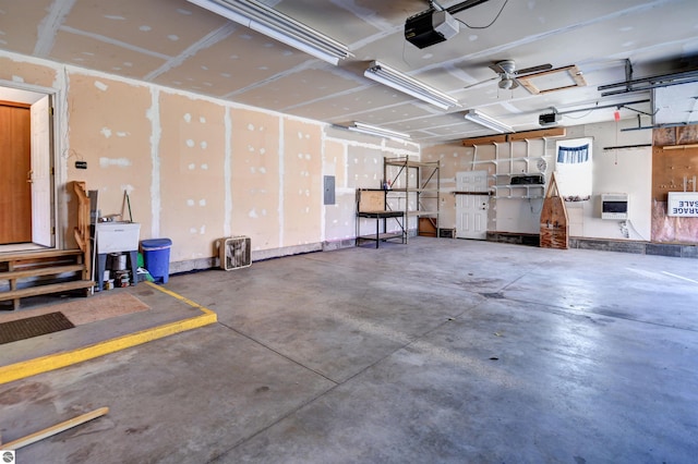 garage with electric panel, heating unit, and a garage door opener