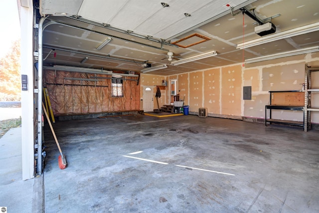 garage with electric panel and a garage door opener