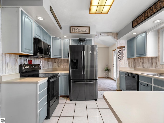 kitchen featuring black appliances and light tile patterned floors