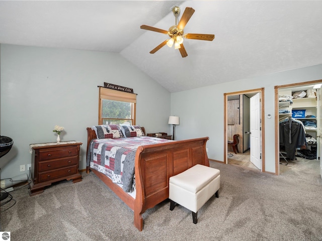 bedroom with a closet, ceiling fan, light carpet, and vaulted ceiling