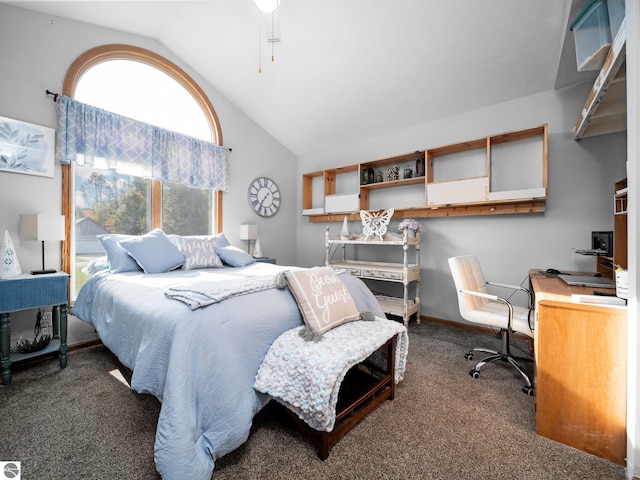 bedroom featuring ceiling fan, vaulted ceiling, and dark carpet