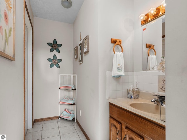 bathroom featuring vanity, decorative backsplash, a textured ceiling, and tile patterned floors