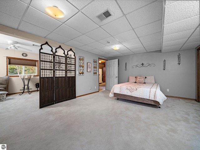 unfurnished bedroom featuring a paneled ceiling and carpet flooring