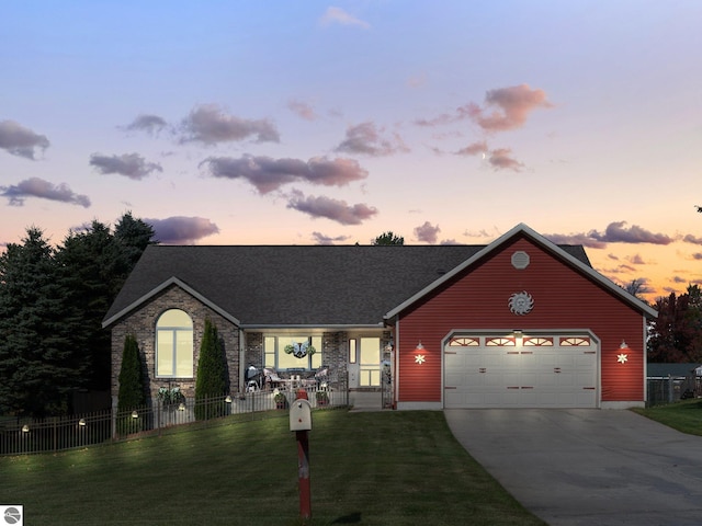 view of front of property with a yard and a garage